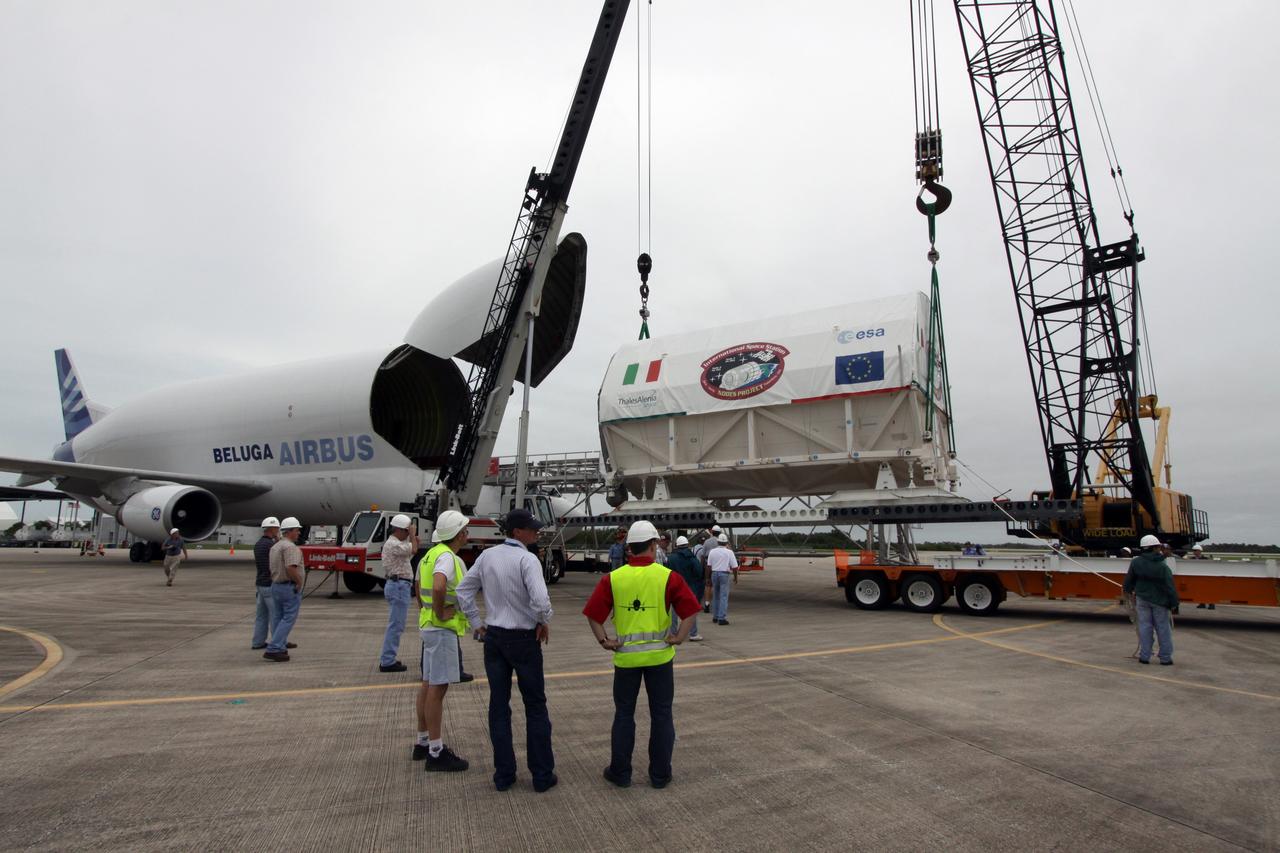CAPE CANAVERAL, Fla. – On the Shuttle Landing Facility at NASA's Kennedy Space Center in Florida, a crane lifts the Node 3 module toward the flatbed that will transport it to the Space Station Processing Facility. Named Tranquility, the module will be delivered to the International Space Station on the STS-130 mission. Tranquility will eventually house the life support equipment necessary for the space station's permanent crew of six. It will also accommodate the European Space Agency's Cupola observation module, a seven-window, dome-shaped structure. Tranquility is targeted for launch aboard space shuttle Endeavour in February 2010. Photo credit: NASA/Jack Pfaller