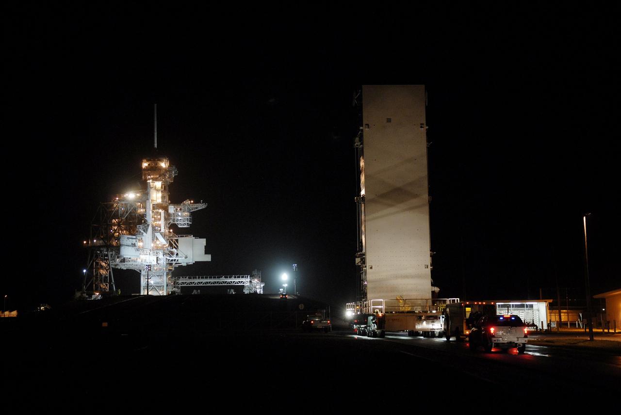 CAPE CANAVERAL, Fla. – The transporter with the payload canister arrives at Launch Pad 39A at NASA's Kennedy Space Center in Florida.  Under lights at left are the rotating and fixed service structures on the pad. Inside the canister is space shuttle Endeavour's payload for the STS-127 mission, which includes the Japan Aerospace Exploration Agency's Kibo Exposed Facility and the Experiment Logistics Module Exposed Section to the International Space Station.  They will be installed on the Kibo laboratory on the station.  Launch of Endeavour is targeted for June 13.  Photo credit: NASA/Kim Shiflett