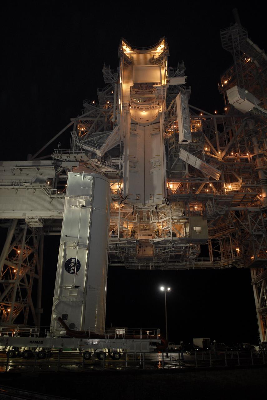 CAPE CANAVERAL, Fla. – – The transporter with the payload canister closes in on the rotating service structure, or RSS, on Launch Pad 39A at NASA's Kennedy Space Center in Florida. When it is under the RSS, the canister will be lifted up into the Payload Changeout Room above. Inside the canister is space shuttle Endeavour's payload for the STS-127 mission, which includes the Japan Aerospace Exploration Agency's Kibo Exposed Facility and the Experiment Logistics Module Exposed Section to the International Space Station. They will be installed on the Kibo laboratory on the station. Launch of Endeavour is targeted for June 13. Photo credit: NASA/Kim Shiflett