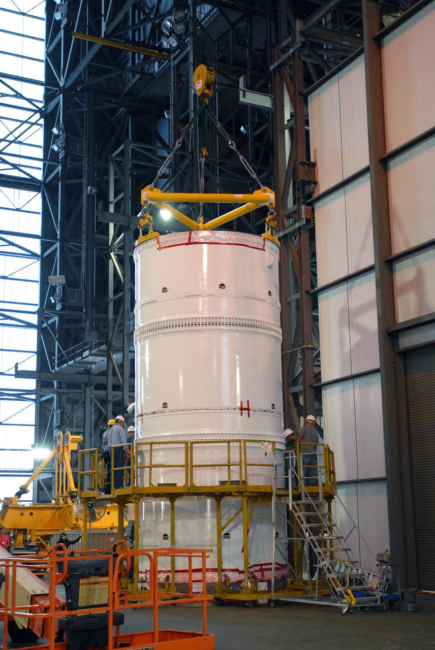 CAPE CANAVERAL, Fla. – In the transfer aisle of the Vehicle Assembly Building at NASA's Kennedy Space Center in Florida, the conjoined forward and center segments of the fifth segment simulator for the Ares I-X is secured to the simulator’s aft segment. Ares I-X is the test vehicle for the Ares I, a component of the Constellation Program to return men to the moon and beyond. Ares I is the essential core of a safe, reliable, cost-effective space transportation system that eventually will carry crewed missions back to the moon, on to Mars and out into the solar system. The launch of the Ares I-X flight test is targeted for August 2009.  Photo credit: NASA/Jim Grossmann