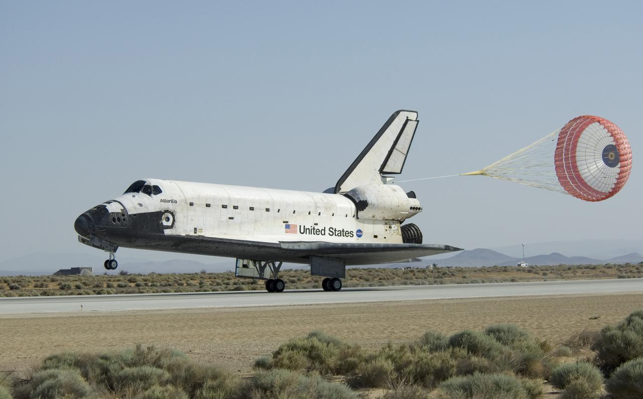 EDWARDS, Calif. - ED09-0127-04 - A drag chute slows the speed of space shuttle Atlantis as it touches down on Runway 22 at Edwards Air Force Base in California, ending a journey of 5.3 million miles on the STS-125 mission to repair and upgrade NASA’s Hubble Space Telescope.  Main gear touchdown was at 11:39:05 a.m. EDT.  Nose gear touchdown was at 11:39:15 a.m. EDT.  Wheel stop was at 11:40:15 a.m., bringing the mission’s elapsed time to 12 days, 21 hours, 37 minutes, 9 seconds.  Landing opportunities on May 22, May 23 and May 24 were waved off due to weather concerns at NASA’s Kennedy Space Center in Florida, the shuttle’s primary landing site. Through five spacewalks, NASA's Hubble Space Telescope was refurbished and upgraded with state-of-the-art science instruments that will expand Hubble's capabilities and extend its operational lifespan through at least 2014.  Photo credit: NASA/Carla Thomas, EAFB