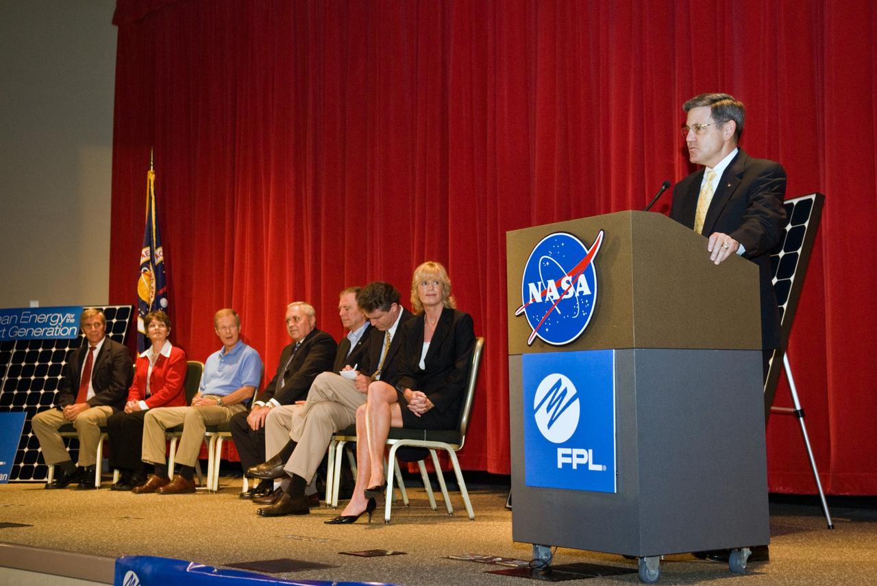 CAPE CANAVERAL, Fla. – Center Director of NASA's Kennedy Space Center in Florida, Bob Cabana addresses guests at the groundbreaking ceremony for the joint NASA and Florida Power & Light, or FPL, solar power project at Kennedy. Others on the stage are (from left) Ed Smeloff with SunPower Corporation, Florida Rep. Suzanne Kosmas, Sen. Bill Nelson, Armando Olivera, president and CEO of FPL, Florida Rep. Bill Posey, Eric Draper, deputy director of Audubon of Florida, and Pam Rauch, vice president of External Affairs for FPL. FPL, Florida's largest electric utility, will build and maintain two solar photovoltaic power generation systems at Kennedy. One will produce an estimated 10 megawatts of emissions-free power for FPL customers, which is enough energy to serve roughly 1,100 homes. The second is a one-megawatt solar power facility that will provide renewable energy directly to Kennedy. The FPL facilities at NASA will help provide Florida residents and America's space program with new sources of clean energy that will cut reliance on fossil fuels and improve the environment by reducing greenhouse gas emissions. The one megawatt facility also will help NASA meet its goal for use of power generated from renewable energy. Photo credit: NASA/Kim Shiflett