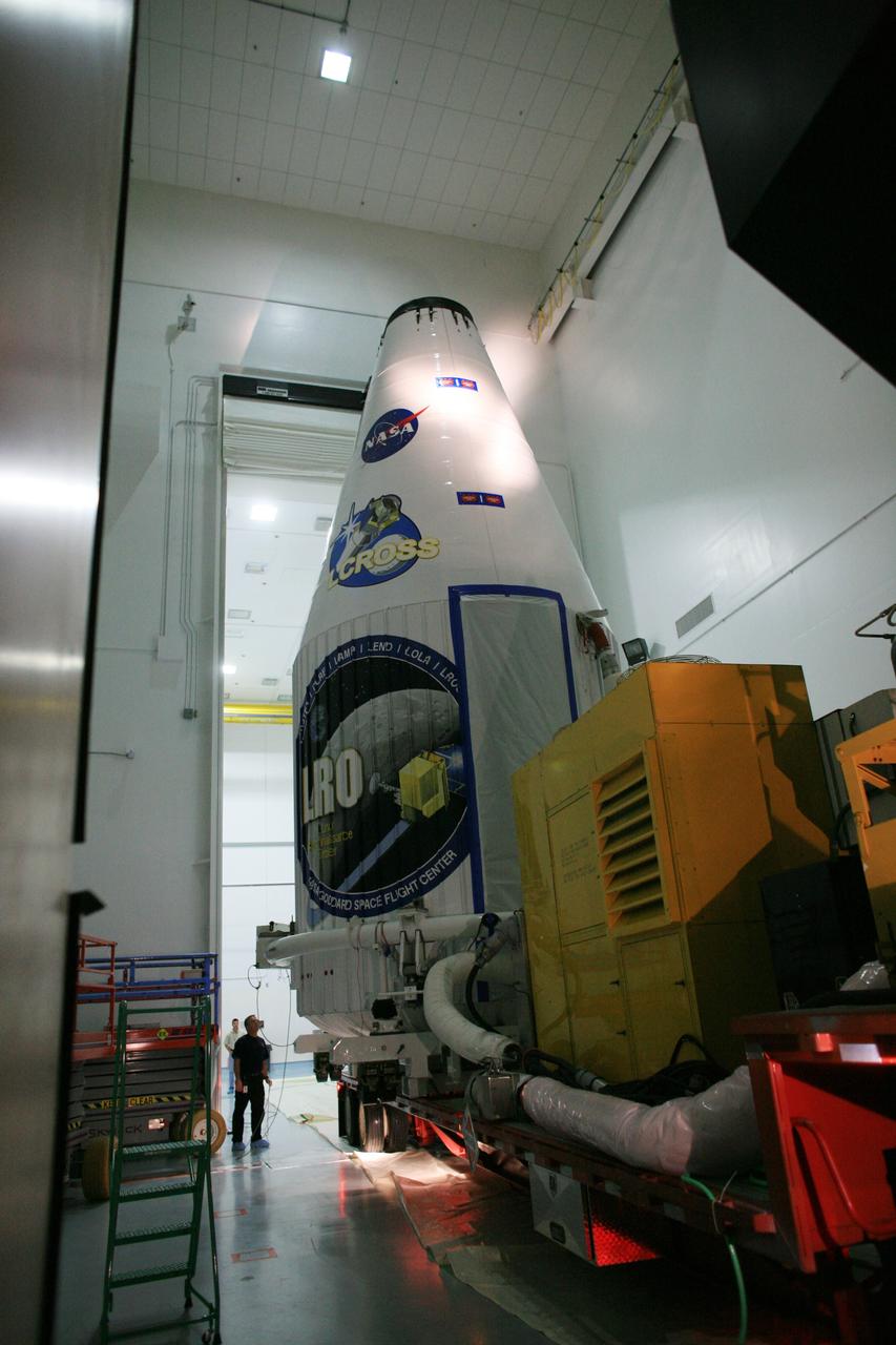 CAPE CANAVERAL, Fla. – Encased in the fairing, the Lunar Reconnaissance Orbiter, or LRO, and NASA's Lunar Crater Observation and Sensing Satellite, known as LCROSS, are moved out of Astrotech Space Operations in Titusville.  It is being transported to Launch Complex 41 at Cape Canaveral Air Force Station in Florida.  The LRO includes five instruments that will help NASA characterize the moon's surface:  DIVINER, LAMP, LEND, LOLA and LROC.  Along with LCROSS, they will be launched aboard an Atlas V/Centaur rocket on June 17. Photo credit: NASA/Dimitri Gerondidakis