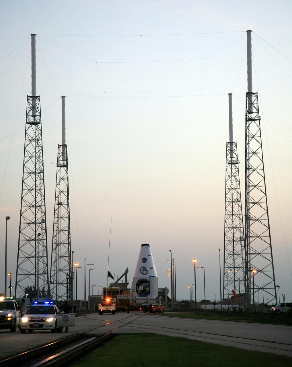CAPE CANAVERAL, Fla. – The Lunar Reconnaissance Orbiter, or LRO, and NASA's Lunar Crater Observation and Sensing Satellite, known as LCROSS, arrive on Launch Complex 41 at Cape Canaveral Air Force Station in Florida.  Surrounding the launch pad are the lightning protection towers. The LRO includes five instruments that will help NASA characterize the moon's surface:  DIVINER, LAMP, LEND, LOLA and LROC.  Along with LCROSS, they will be launched aboard an Atlas V/Centaur rocket on June 17. Photo credit: NASA/Dimitri Gerondidakis