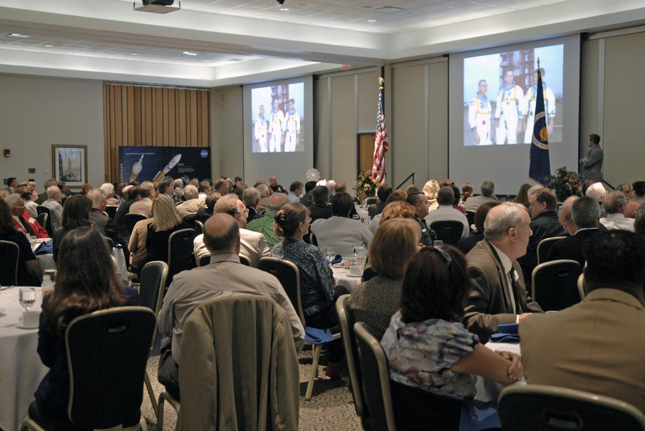 CAPE CANAVERAL, Fla. – Guests at the annual Community Leaders Breakfast held in the Debus Center at Kennedy Space Center's Visitor Complex enjoy reminiscing about the early days of the Space Shuttle Program with Center Director Bob Cabana, far right on stage.  Community leaders, business executives, educators, community organizers and state and local government heard Cabana provide an overview of operations at the space center and a look ahead at upcoming missions and activities. Photo credit: NASA/Kim Shiflett