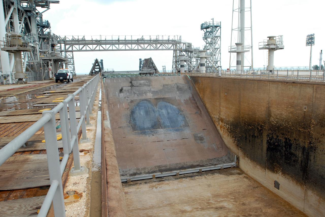 CAPE CANAVERAL, Fla. – A view of the flame trench on Launch Pad 39A at NASA's Kennedy Space Center in Florida where repairs of the Fondue Fyre have been made. After launch of space shuttle Atlantis on the STS-125 mission on May 11, a 25-square-foot area of Fondue Fyre from the north side of the solid rocket booster flame deflector was damaged. Some pneumatic lines (gaseous nitrogen, pressurized air) in the area also were damaged and needed to be repaired. The flame trench channels the flames and smoke exhaust of the shuttle's solid rocket boosters away from the space shuttle during liftoff. Fondue Fyre is a fire-resistant concrete-like material that replaced the original flame trench bricks. It can be sprayed on the surface. Pad 39A will be used for the launch of space shuttle Endeavour on the STS-127 mission targeted for June 13.  Photo credit: NASA/Jim Grossmann