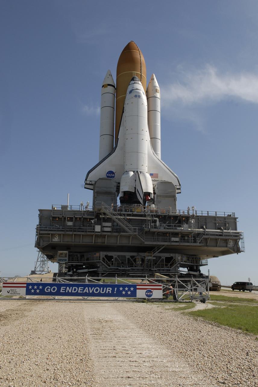 CAPE CANAVERAL, Fla. – At NASA's Kennedy Space Center in Florida, a banner on the perimeter fence of Launch Pad 39A proclaims "Go Endeavour!" as the space shuttle nears the pad. First motion of the 3.4-mile rollaround from Launch Pad 39B was at 3:16 a.m. EDT. Endeavour was on standby on Pad 39B to be used in the unlikely event that a rescue mission was necessary during space shuttle Atlantis' STS-125 mission to NASA's Hubble Space Telescope. The payload on Endeavour's next mission, STS-127, includes the Japan Aerospace Exploration Agency's Kibo Exposed Facility and the Experiment Logistics Module Exposed Section of the International Space Station. They will be installed on the Kibo laboratory already on the station. Launch of STS-127 is targeted for June 13. Photo credit: NASA/Kim Shiflett
