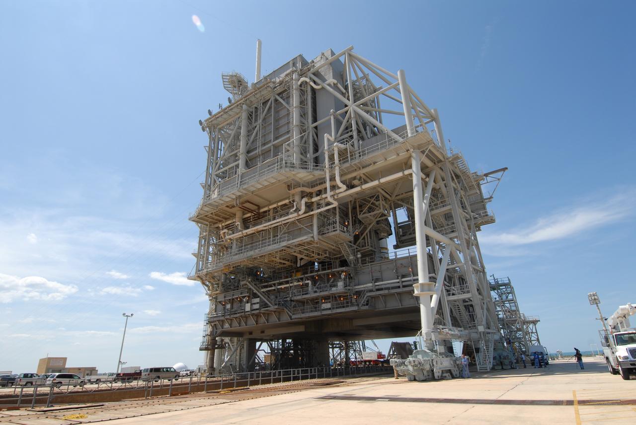 CAPE CANAVERAL, Fla. – On Launch Pad 39A at NASA's Kennedy Space Center in Florida, the rotating service structure has been moved into place around space shuttle Endeavour. The RSS provides protected access to the shuttle for changeout and servicing of payloads at the pad. The structure is supported by a rotating bridge that pivots about a vertical axis on the west side of the pad's flame trench. The RSS rotates through 120 degrees (one-third of a circle) on a radius of 160 feet. Support for the outer end of the bridge is provided by two eight-wheel, motor-driven trucks that move along circular twin rails installed flush with the pad surface. The track crosses the flame trench on a permanent bridge. Endeavour is targeted to launch June 13 on its STS-127 mission to the International Space Station. Photo credit: NASA/Tim Jacobs