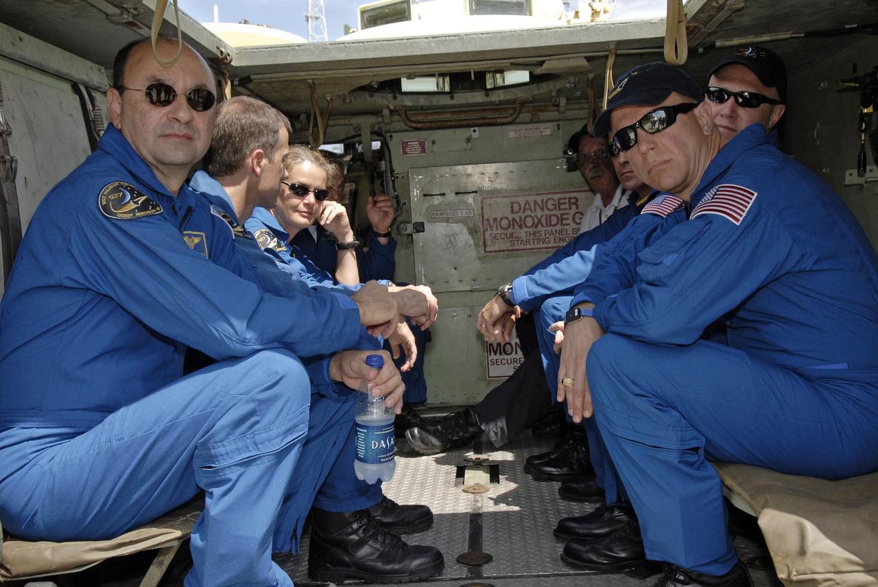 CAPE CANAVERAL, Fla. – The STS-127 crew members sit in the M-113 armored personnel carrier for instructions on driving the M-113 as part of their training on emergency egress procedures. On the left are Commander Mark Polansky and Mission Specialists Tom Marshburn, Julie Payette and Dave Wolf (behind Payette).  On the right are Mission Specialist Christopher Cassidy, Pilot Doug Hurley and Mission Specialist Tim Kopra. The crew members of space shuttle Endeavour's STS-127 mission will each practice driving the M-113. An M-113 will be available to transport the crew to safety in the event of a contingency on the pad before their launch. The crew is at NASA's Kennedy Space Center for a launch dress rehearsal called the terminal countdown demonstration test, or TCDT, which includes the emergency egress training and equipment familiarization.  The STS-127 mission is the final of three flights dedicated to the assembly of the Japanese Kibo laboratory complex.  Endeavour's launch is targeted for June 13.  Photo credit: NASA/Kim Shiflett