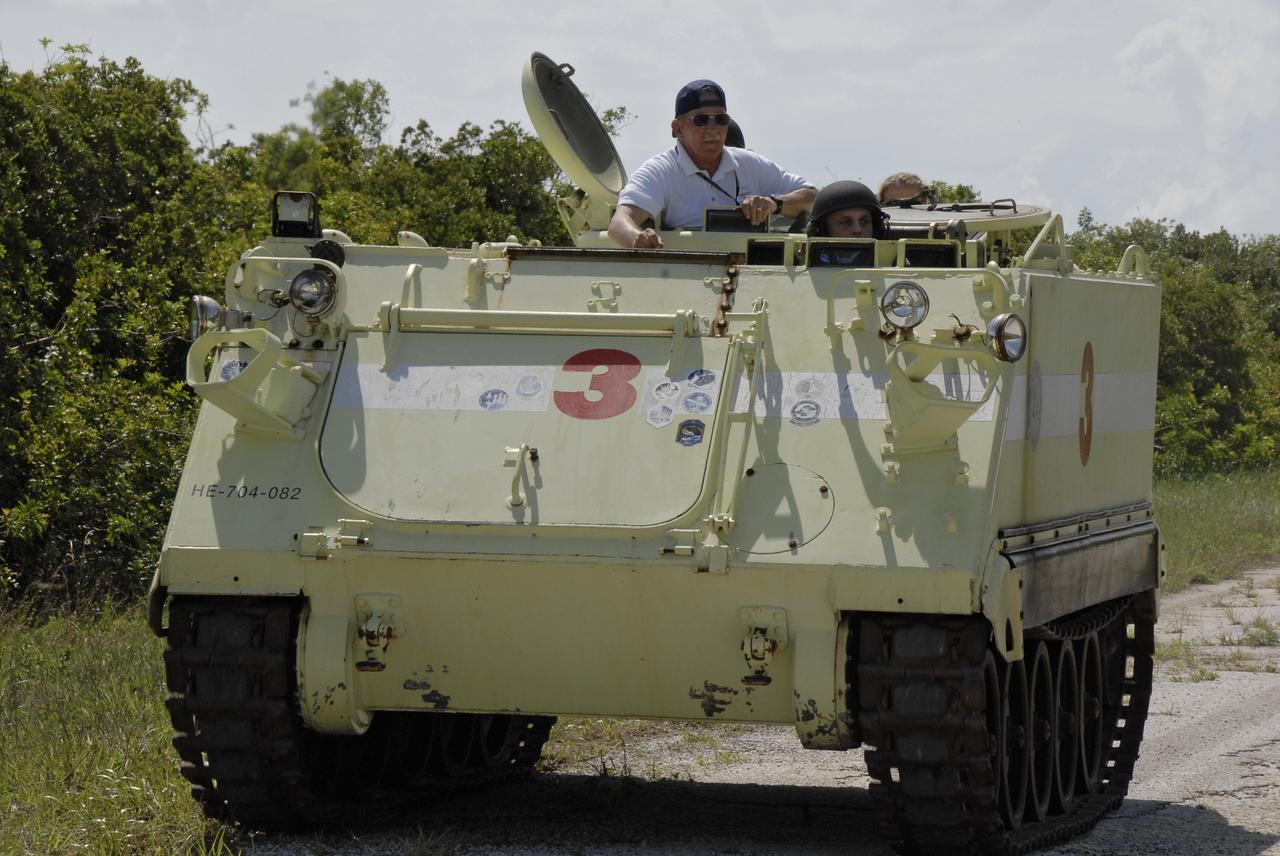 CAPE CANAVERAL, Fla. – STS-127 Mission Specialist Dave Wolf takes the wheel of the M-113 armored personnel carrier.  Driving the M-113 is part of the training on emergency egress procedures. The crew members of space shuttle Endeavour's STS-127 mission are taking turns driving the M-113.  An M-113 will be available to transport the crew to safety in the event of a contingency on the pad before their launch. The crew is at NASA's Kennedy Space Center for a launch dress rehearsal called the terminal countdown demonstration test, or TCDT, which includes the emergency egress training and equipment familiarization.  The STS-127 mission is the final of three flights dedicated to the assembly of the Japanese Kibo laboratory complex.  Endeavour's launch is targeted for June 13.  Photo credit: NASA/Kim Shiflett