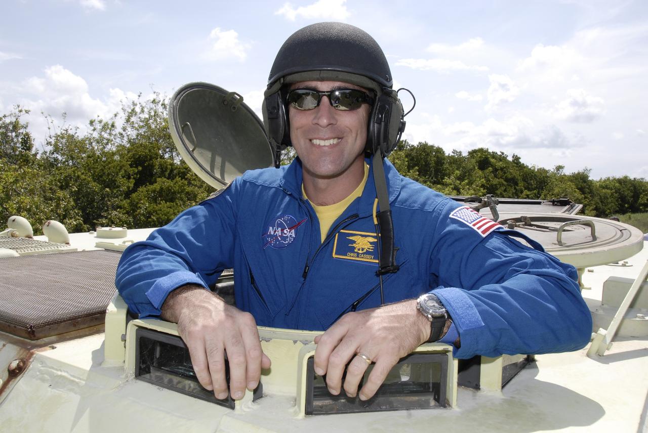 CAPE CANAVERAL, Fla. – STS-127 Mission Specialist Christopher Cassidy is ready to take the wheel to practice driving the M-113 armored personnel carrier, which is part of the training on emergency egress procedures. The crew members of space shuttle Endeavour's STS-127 mission are taking turns driving the M-113.   An M-113 will be available to transport the crew to safety in the event of a contingency on the pad before their launch. The crew is at NASA's Kennedy Space Center for a launch dress rehearsal called the terminal countdown demonstration test, or TCDT, which includes the emergency egress training and equipment familiarization.  The STS-127 mission is the final of three flights dedicated to the assembly of the Japanese Kibo laboratory complex.  Endeavour's launch is targeted for June 13.  Photo credit: NASA/Kim Shiflett