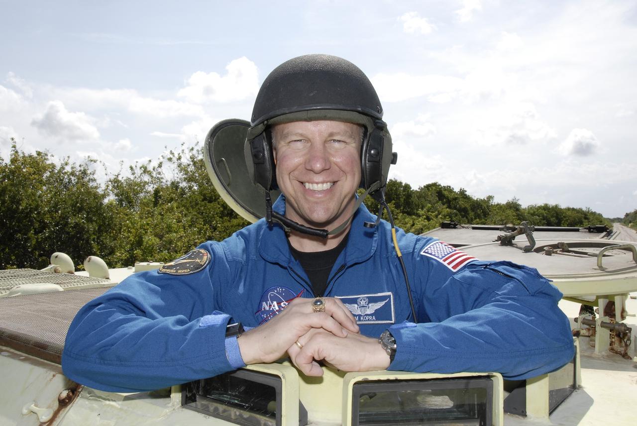 CAPE CANAVERAL, Fla. – STS-127 Mission Specialist Tim Kopra is happy to have successfully driven the M-113 armored personnel carrier, which is part of the training on emergency egress procedures. The crew members of space shuttle Endeavour's STS-127 mission are taking turns driving the M-113.  An M-113 will be available to transport the crew to safety in the event of a contingency on the pad before their launch. The crew is at NASA's Kennedy Space Center for a launch dress rehearsal called the terminal countdown demonstration test, or TCDT, which includes the emergency egress training and equipment familiarization.  The STS-127 mission is the final of three flights dedicated to the assembly of the Japanese Kibo laboratory complex.  Endeavour's launch is targeted for June 13.  Photo credit: NASA/Kim Shiflett