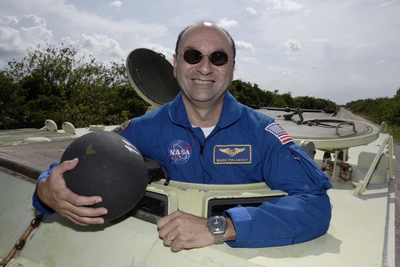 CAPE CANAVERAL, Fla. – STS-127 Commander Mark Polansky smiles after practicing driving the M-113 armored personnel carrier. The crew members of space shuttle Endeavour's STS-127 mission will each practice driving the M-113 in turn as part of their training on emergency egress procedures. An M-113 will be available to transport the crew to safety in the event of a contingency on the pad before their launch. The crew is at NASA's Kennedy Space Center for a launch dress rehearsal called the terminal countdown demonstration test, or TCDT, which includes the emergency egress training and equipment familiarization.  The STS-127 mission is the final of three flights dedicated to the assembly of the Japanese Kibo laboratory complex.  Endeavour's launch is targeted for June 13.  Photo credit: NASA/Kim Shiflett