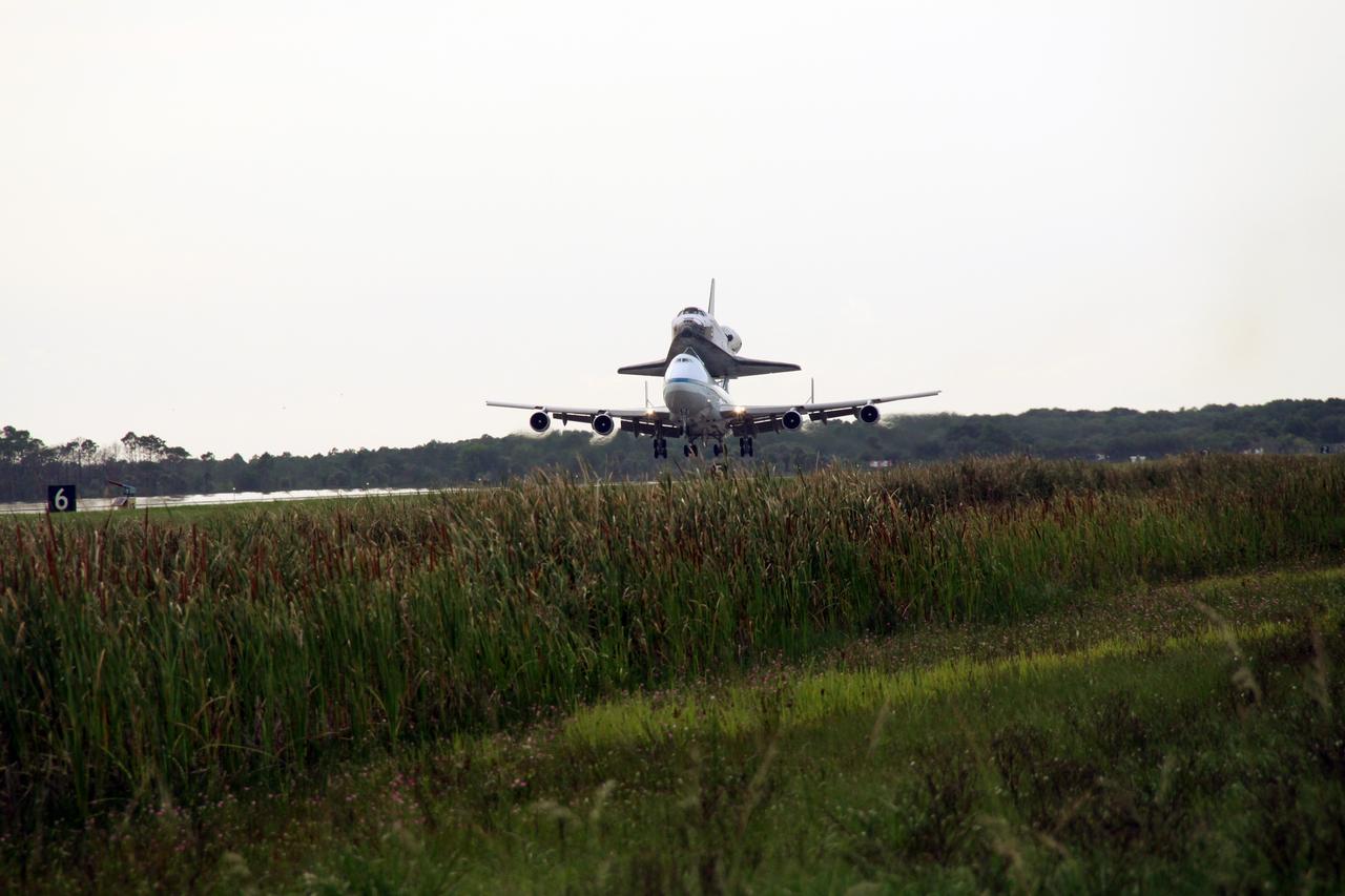 CAPE CANAVERAL, Fla. – After a two-day trip from California, the wheels of the Shuttle Carrier Aircraft, or SCA, with space shuttle Atlantis secured to its back, near contact with NASA Kennedy Space Center's Shuttle Landing Facility runway 15. The SCA is a modified Boeing 747 jetliner. Visible on Atlantis is the tail cone, which protects the aft engine area and provides a more efficient aeronautical dimension during flight. Atlantis returned from California atop the SCA after its May 24 landing at Edwards Air Force Base, concluding mission STS-125. The ferry flight from Edwards Air Force Base began June 1. Touchdown at Kennedy was at 6:53 p.m. EDT. Photo credit: NASA/Jack Pfaller