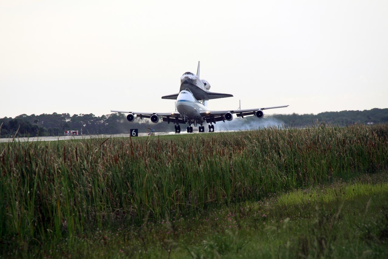 CAPE CANAVERAL, Fla. – After a two-day trip from California, the wheels of the Shuttle Carrier Aircraft, or SCA, with space shuttle Atlantis secured to its back, contact runway 15 at NASA Kennedy Space Center's Shuttle Landing Facility. The SCA is a modified Boeing 747 jetliner. Visible on Atlantis is the tail cone, which protects the aft engine area and provides a more efficient aeronautical dimension during flight. Atlantis returned from California atop the SCA after its May 24 landing at Edwards Air Force Base, concluding mission STS-125. The ferry flight from Edwards Air Force Base began June 1. Touchdown at Kennedy was at 6:53 p.m. EDT. Photo credit: NASA/Jack Pfaller