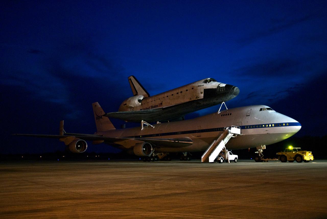 CAPE CANAVERAL, Fla. – Space shuttle Atlantis on top of the Shuttle Carrier Aircraft, or SCA, is parked on the tarmac of NASA Kennedy Space Center's Shuttle Landing Facility. The SCA landed at Kennedy after a more than 2,500-mile cross-country ferry flight from NASA's Dryden Flight Research Center at Edwards Air Force Base in Southern California. The SCA is a modified Boeing 747 jetliner. Atlantis returned from California atop the SCA after its May 24 landing at Edwards Air Force Base, concluding mission STS-125. The ferry flight from Edwards began June 1. Atlantis' next assignment is the STS-129 mission, targeted to launch in November 2009. Photo credit: NASA/Kim Shiflett