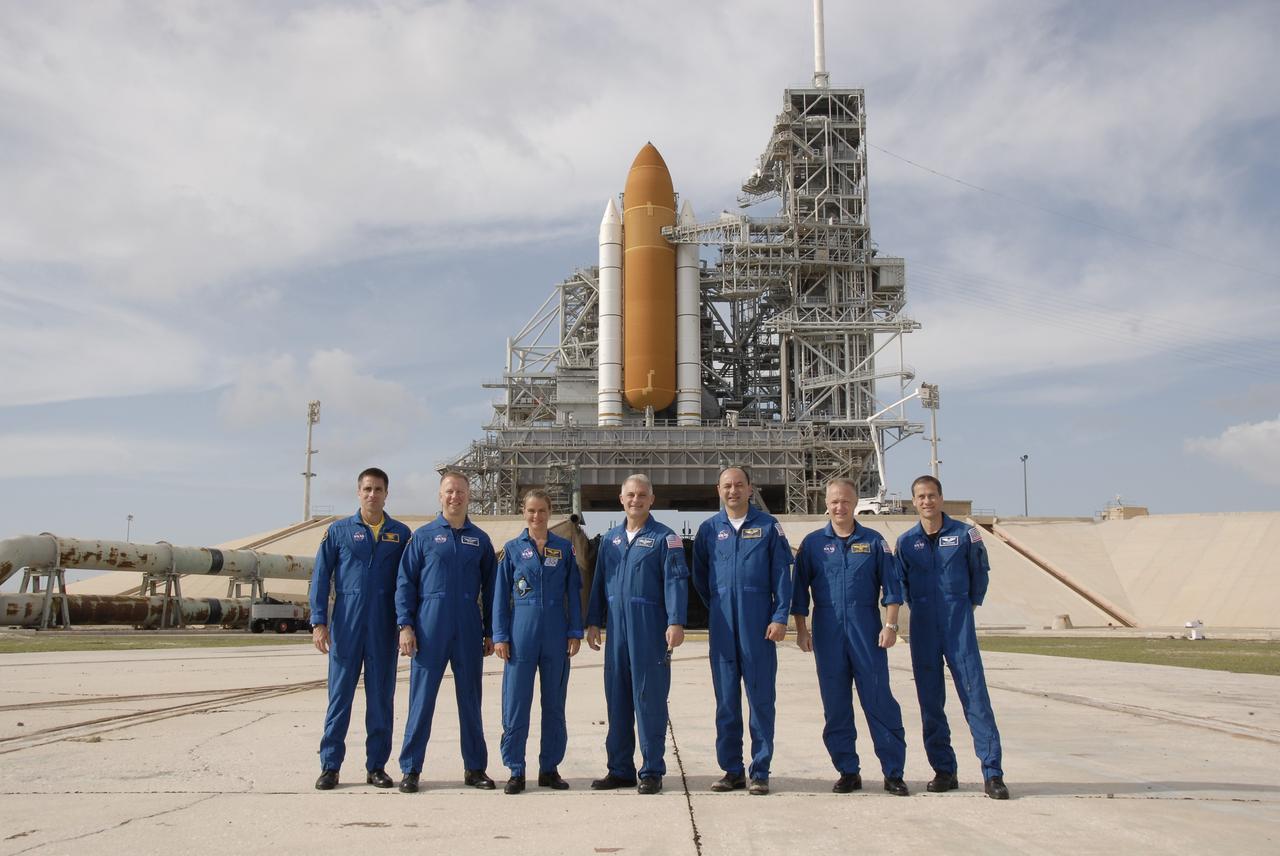 CAPE CANAVERAL, Fla. –  STS-127 crew members gather at NASA Kennedy Space Center's Launch Pad 39A for a question-and-answer session with the media.  From left are Mission Specialist Christopher Cassidy, Tim Kopra, Julie Payette and Dave Wolf, Commander Mark Polansky, Pilot Doug Hurley and Mission Specialist Tom Marshburn.  Payette represents the Canadian Space Agency.  In the background is the fixed service structure with the solid rocket boosters and external fuel tank attached to space shuttle Endeavour. The crew is at Kennedy for a launch dress rehearsal called the terminal countdown demonstration test, or TCDT, which includes emergency egress training and equipment familiarization.  Space shuttle Endeavour's STS-127 mission is the final of three flights dedicated to the assembly of the Japanese Kibo laboratory complex on the International Space Station.  Endeavour's launch is targeted for June 13.    Photo credit: NASA/Kim Shiflett