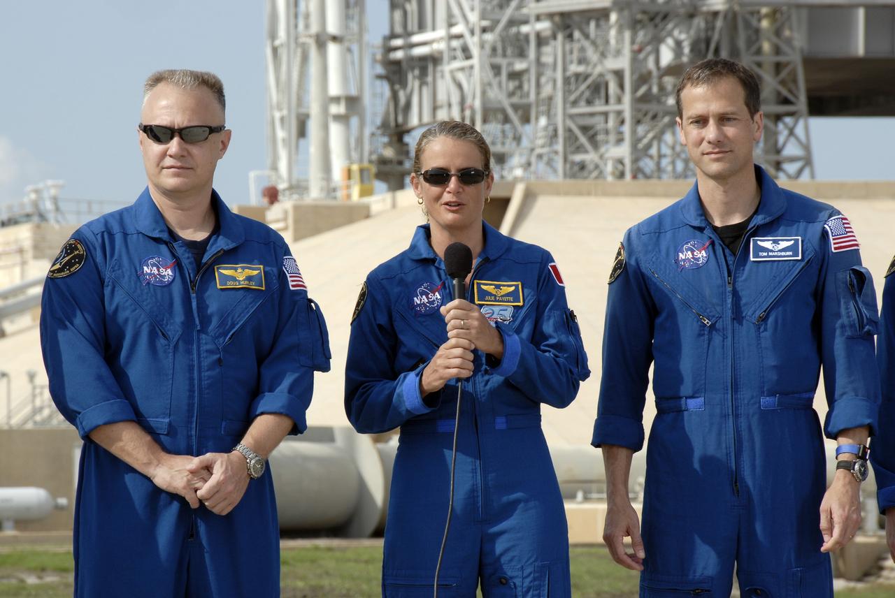 CAPE CANAVERAL, Fla. –  The STS-127 crew members stand at NASA Kennedy Space Center's Launch Pad 39A for a question-and-answer session with the media.  Mission Specialist Julie Payette talks about her role in the upcoming mission to the International Space Station.  At left is Pilot Doug Hurley; at right is Mission Specialist Tom Marshburn.  Payette represents the Canadian Space Agency.  The crew is at Kennedy for a launch dress rehearsal called the terminal countdown demonstration test, or TCDT, which includes emergency egress training and equipment familiarization.  Space shuttle Endeavour's STS-127 mission is the final of three flights dedicated to the assembly of the Japanese Kibo laboratory complex on the International Space Station.  Endeavour's launch is targeted for June 13.    Photo credit: NASA/Kim Shiflett