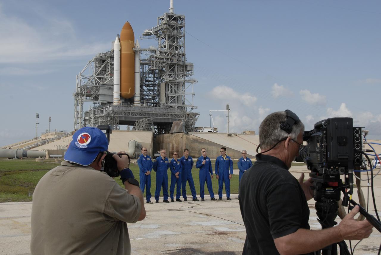 CAPE CANAVERAL, Fla. –  Photographers and videographers capture the STS-127 crew during a question-and-answer session with the media at NASA Kennedy Space Center's Launch Pad 39A.   Standing behind the pad are, from left, Commander Mark Polansky, , Pilot Doug Hurley and Mission Specialists Julie Payette, Tom Marshburn, Tim Kopra, Christopher Cassidy and Dave Wolf.  Payette represents the Canadian Space Agency. The crew is at Kennedy for a launch dress rehearsal called the terminal countdown demonstration test, or TCDT, which includes emergency egress training and equipment familiarization.  Space shuttle Endeavour's STS-127 mission is the final of three flights dedicated to the assembly of the Japanese Kibo laboratory complex on the International Space Station.  Endeavour's launch is targeted for June 13.    Photo credit: NASA/Kim Shiflett