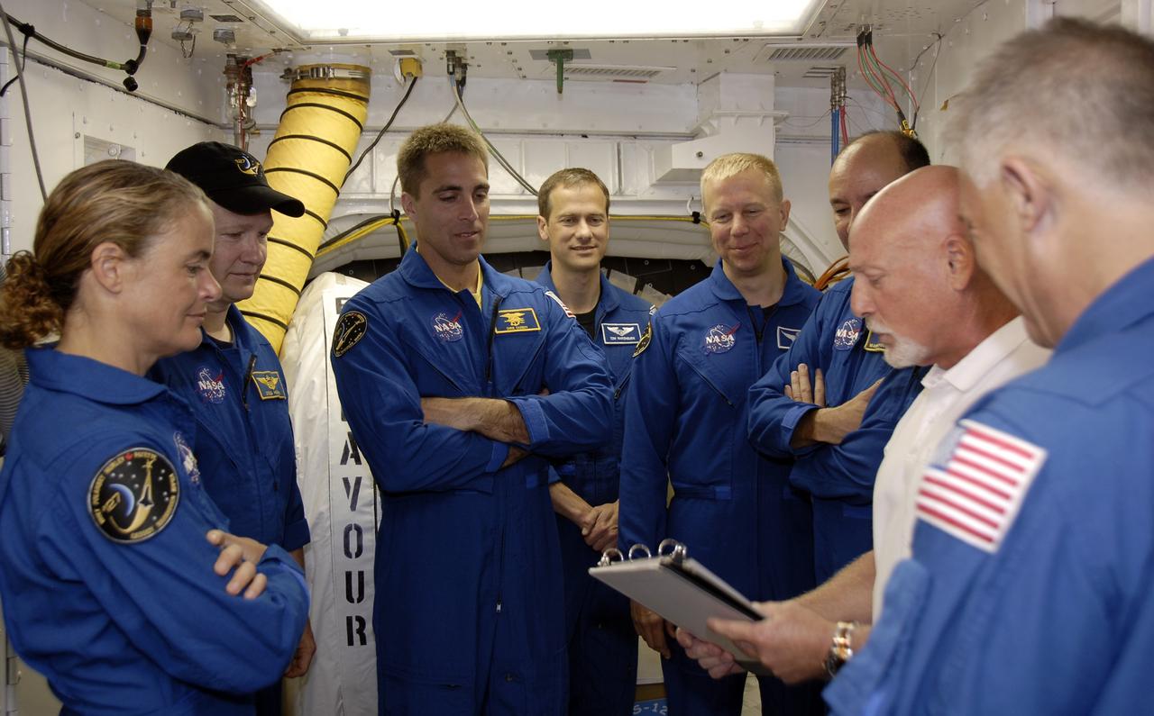 CAPE CANAVERAL, Fla. –  On Launch Pad 39A at NASA's Kennedy Space Center in Florida, STS-127 crew members listen to instructions about emergency exit from the shuttle.  The astronauts are, clockwise from left, Mission Specialist Julie Payette, Pilot Doug Hurley, Mission Specialists Christopher Cassidy and Tim Kopra, and Commander Mark Polansky.  At far right is Mission Specialist Dave Wolf. Payette represents the Canadian Space Agency.  The crew is at Kennedy for a launch dress rehearsal called the terminal countdown demonstration test, or TCDT, which includes emergency exit training and equipment familiarization.  Endeavour's STS-127 mission is the final of three flights dedicated to the assembly of the Japanese Kibo laboratory complex on the International Space Station.  Endeavour's launch is targeted for June 13.   Photo credit: NASA/Kim Shiflett