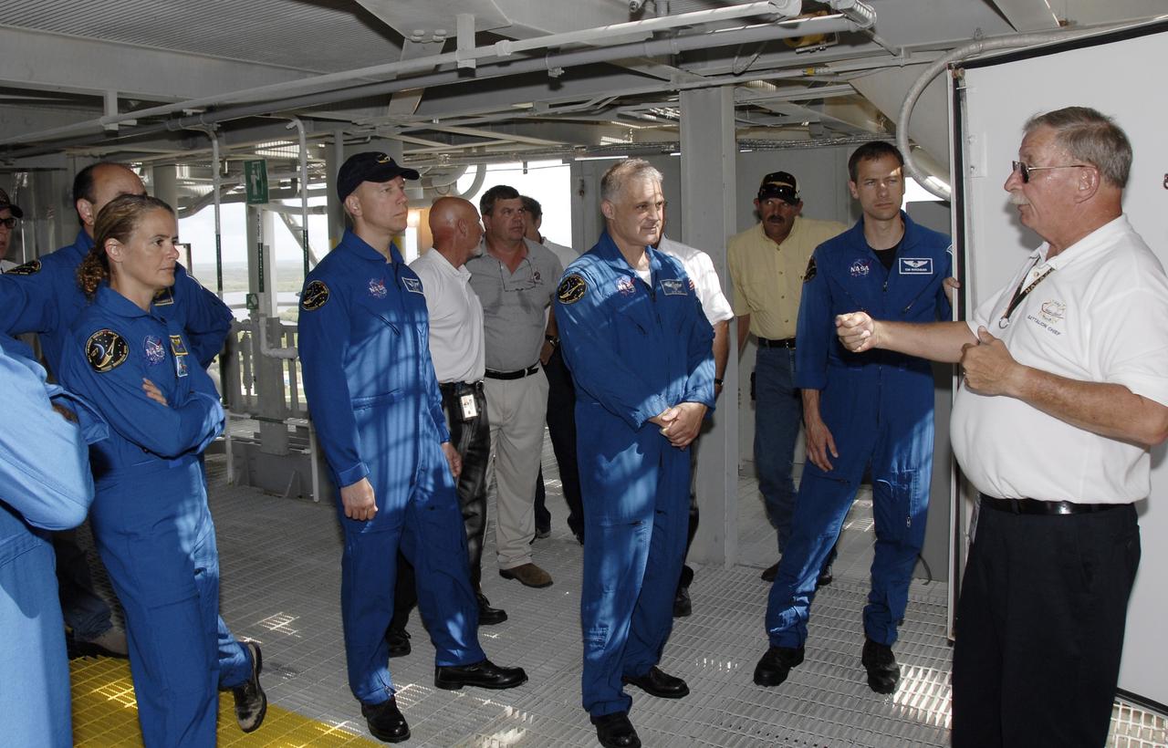 CAPE CANAVERAL, Fla. –  On Launch Pad 39A at NASA's Kennedy Space Center in Florida, STS-127 crew members listen to instructions about emergency exit from the shuttle.  Standing left to right are Mission Specialist Julie Payette, Commander Mark Polansky (behind Payette), Mission Specialists Tim Kopra, Dave Wolf and Tom Marshburn.  Payette represents the Canadian Space Agency.  The crew is at Kennedy for a launch dress rehearsal called the terminal countdown demonstration test, or TCDT, which includes emergency exit training and equipment familiarization.  Endeavour's STS-127 mission is the final of three flights dedicated to the assembly of the Japanese Kibo laboratory complex on the International Space Station.  Endeavour's launch is targeted for June 13.   Photo credit: NASA/Kim Shiflett