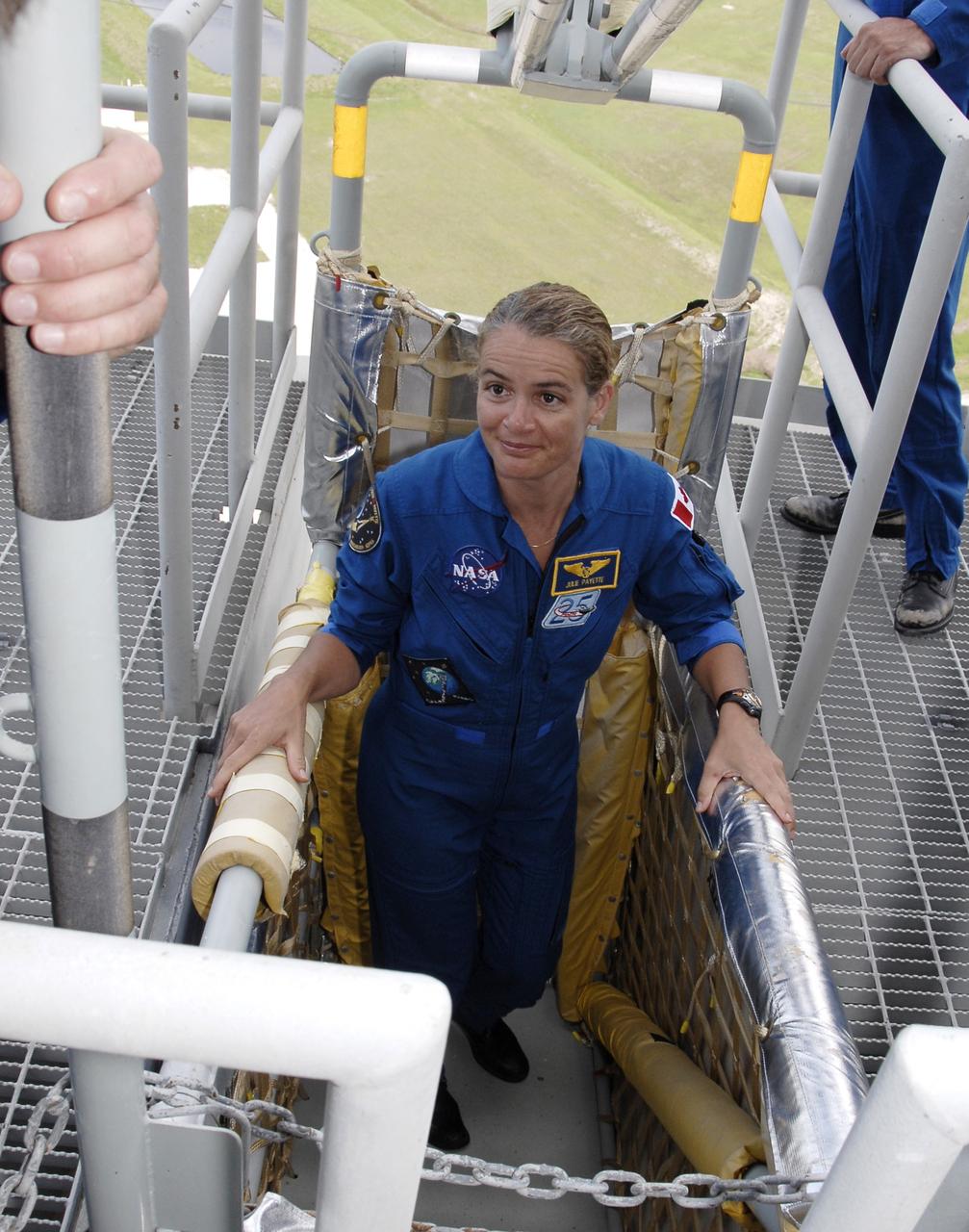 CAPE CANAVERAL, Fla. –  On Launch Pad 39A at NASA's Kennedy Space Center in Florida, STS-127 Mission Specialist Julie Payette gets into the slidewire basket that is part of emergency exit equipment.  She and other crew members are learning about emergency procedures from the launch pad. The crew is at Kennedy for a launch dress rehearsal called the terminal countdown demonstration test, or TCDT, which includes emergency exit training and equipment familiarization.  Endeavour's STS-127 mission is the final of three flights dedicated to the assembly of the Japanese Kibo laboratory complex on the International Space Station.  Endeavour's launch is targeted for June 13.   Photo credit: NASA/Kim Shiflett