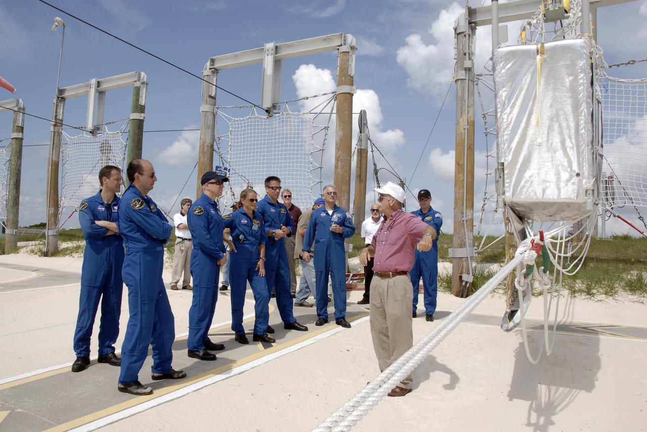 CAPE CANAVERAL, Fla. –  At the slidewire basket landing area near Launch Pad 39A at NASA's Kennedy Space Center in Florida, STS-127 crew members learn about landing procedures during an emergency exit from the pad.  From left are Mission Specialist Tom Marshburn, Commander Mark Polansky, and Mission Specialists Tim Kopra, Julie Payette, Christopher Cassidy, Dave  Wolf and (far right) Pilot Doug Hurley. The crew is at Kennedy for a launch dress rehearsal called the terminal countdown demonstration test, or TCDT, which includes emergency exit training and equipment familiarization.  Endeavour's STS-127 mission is the final of three flights dedicated to the assembly of the Japanese Kibo laboratory complex on the International Space Station.  Endeavour's launch is targeted for June 13.   Photo credit: NASA/Kim Shiflett