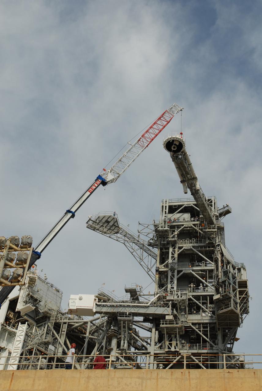 CAPE CANAVERAL, Fla. – On Launch Pad 39B at NASA's Kennedy Space Center in Florida, a crane is attached to the oxygen vent hood, called the "beanie cap," on the gaseous oxygen vent arm, for removal. A portion of the service structure is being removed for the pad's conversion as launch site for the Constellation Program's Ares I-X. The launch of the Ares I-X flight test is targeted for August 2009. Photo credit: NASA/Jim Grossmann