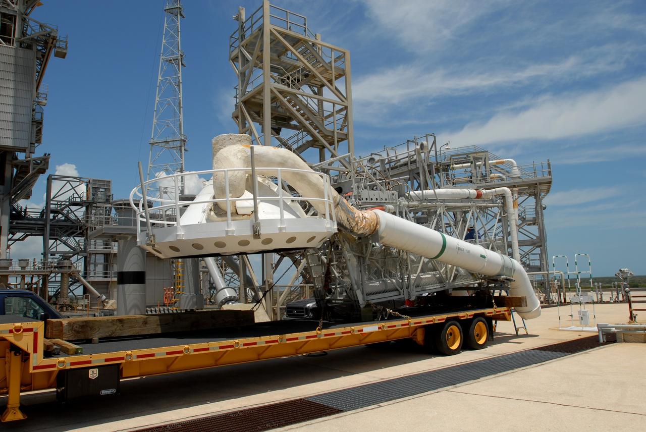 CAPE CANAVERAL, Fla. – At NASA's Kennedy Space Center in Florida, the oxygen vent hood, called the "beanie cap," and the gaseous oxygen vent arm removed from Launch Pad 39B's fixed service structure are lowered onto a transporter. A portion of the service structure is being removed for the pad's conversion as launch site for the Constellation Program's Ares I-X. The launch of the Ares I-X flight test is targeted for August 2009. Photo credit: NASA/Jim Grossmann