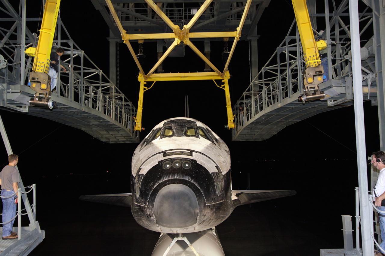 CAPE CANAVERAL, Fla. – After dark, space shuttle Atlantis, atop a Shuttle Carrier Aircraft, or SCA, rolls into place under the mate/demate device on the Shuttle Landing Facility at NASA's Kennedy Space Center in Florida. The hoist seen above Atlantis will lift the shuttle from the SCA and place it on the ground. Atlantis returned from California atop the SCA after its May 24 landing at Edwards Air Force Base, concluding mission STS-125. The ferry flight from Edwards Air Force Base began June 1. Atlantis' next assignment is the STS-129 mission, targeted to launch in November 2009. Photo credit: NASA/Jack Pfaller