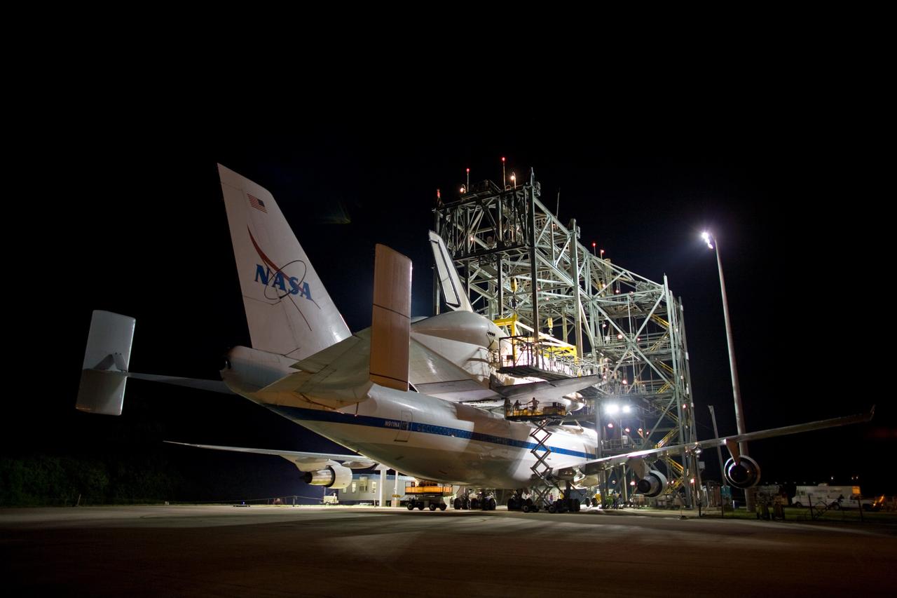 CAPE CANAVERAL, Fla. – Just before sunrise, preparations are underway to separate space shuttle Atlantis from the Shuttle Carrier Aircraft, or SCA, underneath via the mate/demate device on the Shuttle Landing Facility at NASA's Kennedy Space Center in Florida. The hoist is attached to Atlantis to lower the shuttle to the ground. Atlantis returned from California atop the SCA after its May 24 landing at Edwards Air Force Base, concluding mission STS-125. The ferry flight from Edwards Air Force Base began June 1. Atlantis' next assignment is the STS-129 mission, targeted to launch in November 2009. Photo credit: NASA/Dimitri Gerondidakis