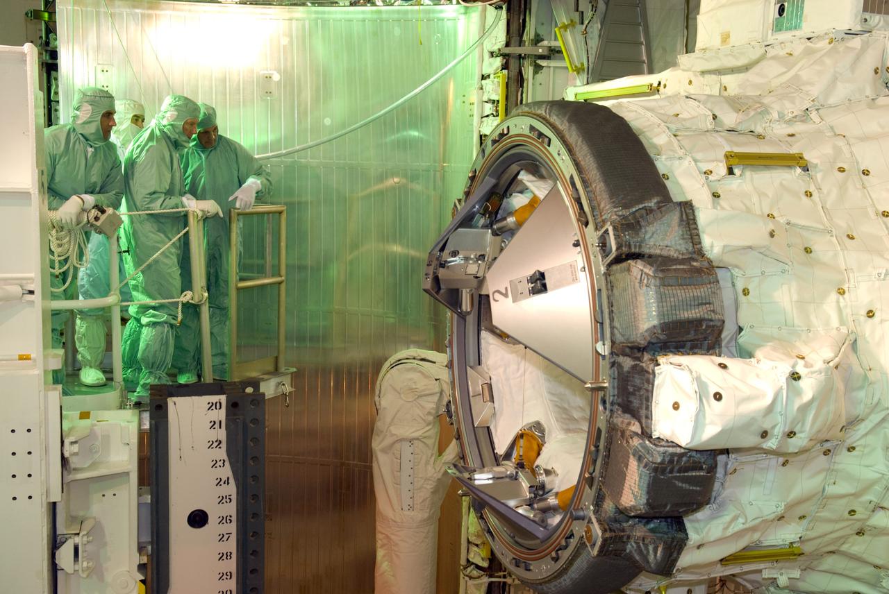 CAPE CANAVERAL, Fla. – On Launch Pad 39A at NASA's Kennedy Space Center in Florida, STS-127 crew members get a close look at space shuttle Endeavour's payload bay. Here Mission Specialists Christopher Cassidy and Tim Kopra and Commander Mark Polansky look at the docking adapter. The payload includes the Japanese Experiment Module's Exposed Facility, or JEM-EF and the Experiment Logistics Module-Exposed Section, or ELM-ES. The astronauts are at Kennedy to prepare for launch through Terminal Countdown Demonstration Test activities. The TCDT includes equipment familiarization and a simulated launch countdown. Endeavour's STS-127 mission is the final of three flights dedicated to the assembly of the Japanese Kibo laboratory complex on the International Space Station. Endeavour's launch is targeted for June 13. Photo credit: NASA/Kim Shiflett