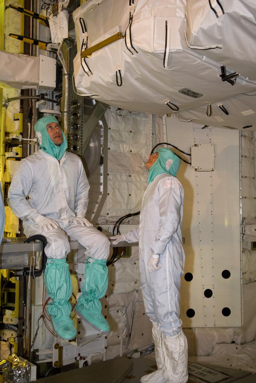 CAPE CANAVERAL, Fla. – On Launch Pad 39A at NASA's Kennedy Space Center in Florida, STS-127 Mission Specialists Tom Marshburn (left) and Julie Payette get a close look at the payload in space shuttle Endeavour's payload bay. The payload includes the Japanese Experiment Module's Exposed Facility, or JEM-EF and the Experiment Logistics Module-Exposed Section, or ELM-ES. The astronauts are at Kennedy to prepare for launch through Terminal Countdown Demonstration Test activities. The TCDT includes equipment familiarization and a simulated launch countdown. Endeavour's STS-127 mission is the final of three flights dedicated to the assembly of the Japanese Kibo laboratory complex on the International Space Station. Endeavour's launch is targeted for June 13. Photo credit: NASA/Kim Shiflett