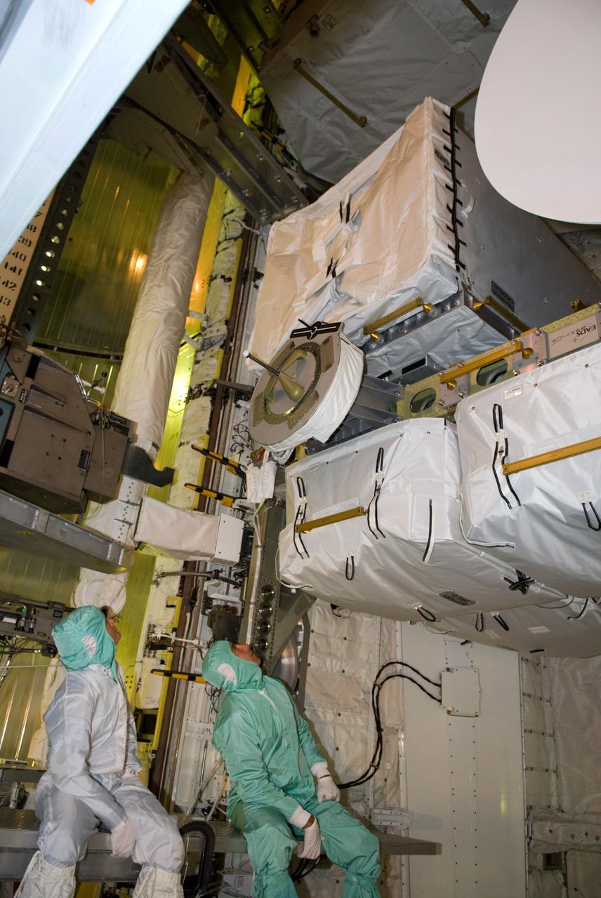 CAPE CANAVERAL, Fla. – – On Launch Pad 39A at NASA's Kennedy Space Center in Florida, STS-127 Mission Specialists Julie Payette (left) and Tom Marshburn get a close look at the payload in space shuttle Endeavour's payload bay. The payload includes the Japanese Experiment Module's Exposed Facility, or JEM-EF and the Experiment Logistics Module-Exposed Section, or ELM-ES. The astronauts are at Kennedy to prepare for launch through Terminal Countdown Demonstration Test activities. The TCDT includes equipment familiarization and a simulated launch countdown. Endeavour's STS-127 mission is the final of three flights dedicated to the assembly of the Japanese Kibo laboratory complex on the International Space Station. Endeavour's launch is targeted for June 13. Photo credit: NASA/Kim Shiflett