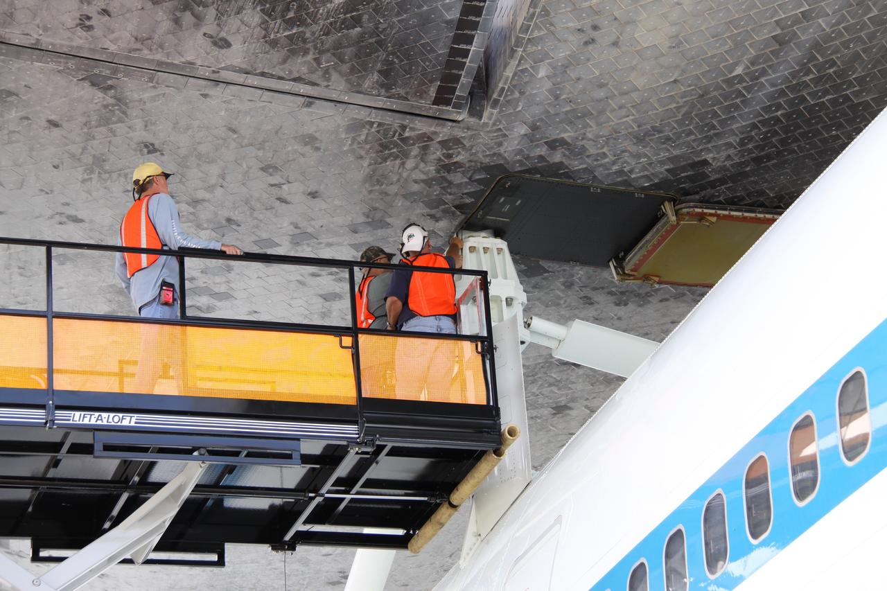 CAPE CANAVERAL, Fla. – Work is under way to separate space shuttle Atlantis from the Shuttle Carrier Aircraft, or SCA, underneath via the mate/demate device on the Shuttle Landing Facility at NASA's Kennedy Space Center in Florida. Workers are removing the struts that attached Atlantis to the SCA. A hoist attached to Atlantis will suspend the shuttle while the SCA is moved away. Atlantis returned from California atop the SCA, a modified Boeing 747, after its May 24 landing at Edwards Air Force Base, concluding mission STS-125. The ferry flight from Edwards Air Force Base began June 1. Atlantis' next assignment is the STS-129 mission, targeted to launch in November 2009. Photo credit: NASA/Jack Pfaller