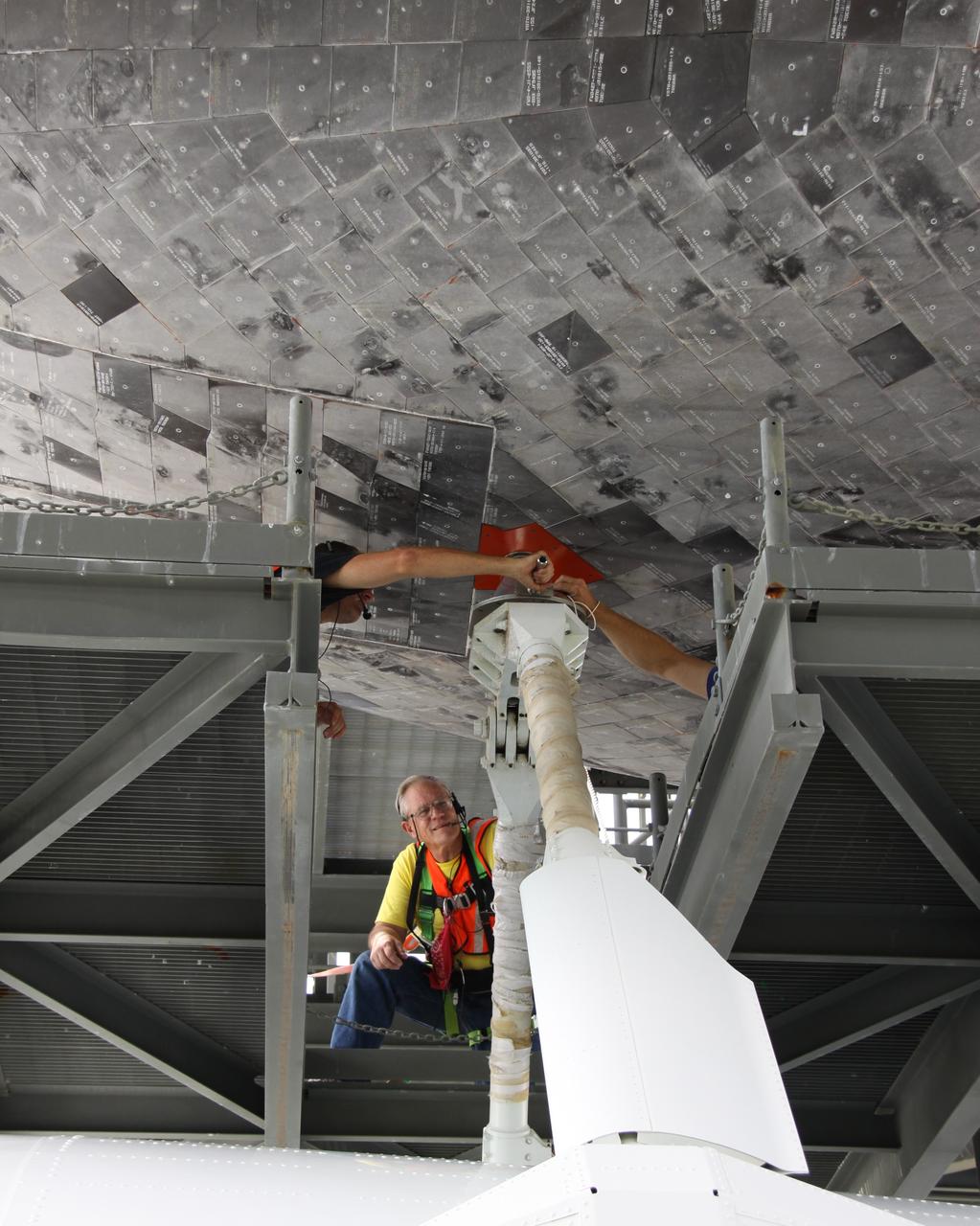 CAPE CANAVERAL, Fla. – Work is under way to separate space shuttle Atlantis from the Shuttle Carrier Aircraft, or SCA, underneath via the mate/demate device on the Shuttle Landing Facility at NASA's Kennedy Space Center in Florida. Workers are removing the struts that attached Atlantis to the SCA. A hoist attached to Atlantis will suspend the shuttle while the SCA is moved away. Atlantis returned from California atop the SCA, a modified Boeing 747, after its May 24 landing at Edwards Air Force Base, concluding mission STS-125. The ferry flight from Edwards Air Force Base began June 1. Atlantis' next assignment is the STS-129 mission, targeted to launch in November 2009. Photo credit: NASA/Jack Pfaller
