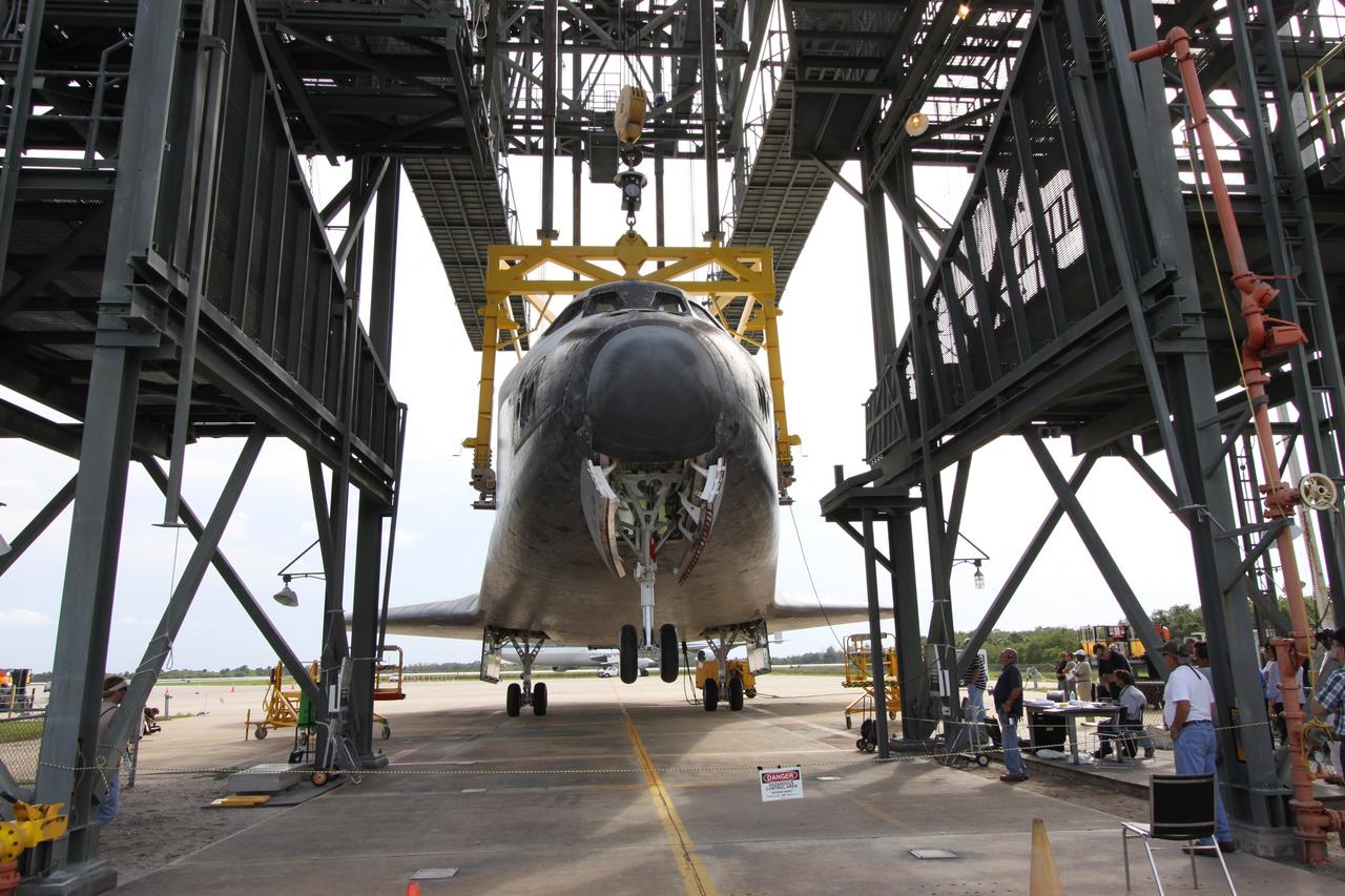 CAPE CANAVERAL, Fla. – With wheels lowered, Atlantis is placed on the ground via the hoist that is suspending it in the mate/demate device. Atlantis was separated from the Shuttle Carrier Aircraft, or SCA, a modified Boeing 747, that returned it from California after its May 24 landing at Edwards Air Force Base, concluding mission STS-125. The ferry flight from Edwards Air Force Base began June 1. Atlantis' next assignment is the STS-129 mission, targeted to launch in November 2009. Photo credit: NASA/Jack Pfaller