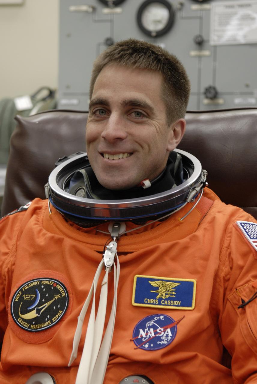 CAPE CANAVERAL, Fla. –  In the Operations and Checkout Building at NASA's Kennedy Space Center in Florida, STS-127 Mission Specialist Christopher Cassidy puts on his launch-and-entry suit. He and other crew members will be heading for Launch Pad 39A for a simulated launch countdown. The crew is at Kennedy for a launch dress rehearsal called the terminal countdown demonstration test, or TCDT, which includes emergency exit training and equipment familiarization.  Endeavour's STS-127 mission is the final of three flights dedicated to the assembly of the Japanese Kibo laboratory complex on the International Space Station.  Endeavour's launch is scheduled for June 13 at 7:17 a.m. EDT.  Photo credit: NASA/Kim Shiflett