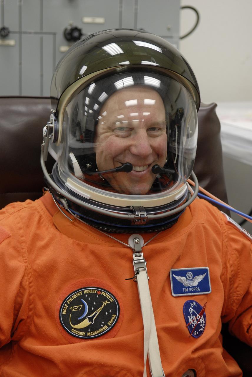CAPE CANAVERAL, Fla. –  In the Operations and Checkout Building at NASA's Kennedy Space Center in Florida, STS-127 Mission Specialist Tim Kopra checks the communication system in his helmet. He and other crew members will be heading for Launch Pad 39A for a simulated launch countdown.  The crew is at Kennedy for a launch dress rehearsal called the terminal countdown demonstration test, or TCDT, which includes emergency exit training and equipment familiarization.  Endeavour's STS-127 mission is the final of three flights dedicated to the assembly of the Japanese Kibo laboratory complex on the International Space Station.  Endeavour's launch is scheduled for June 13 at 7:17 a.m. EDT.  Photo credit: NASA/Kim Shiflett