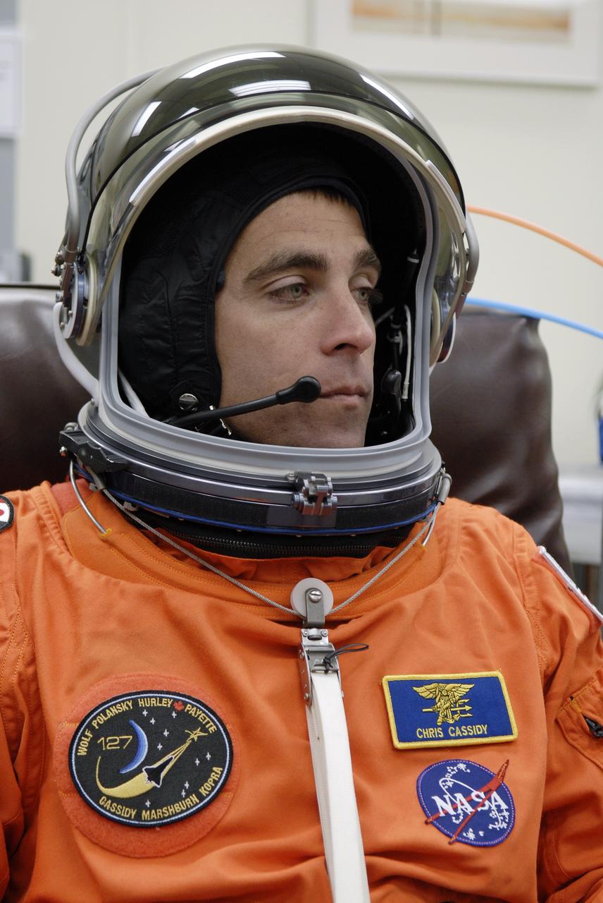 CAPE CANAVERAL, Fla. –  In the Operations and Checkout Building at NASA's Kennedy Space Center in Florida, STS-127 Mission Specialist Christopher Cassidy checks the communication system in his helmet. He and other crew members will be heading for Launch Pad 39A for a simulated launch countdown.  The crew is at Kennedy for a launch dress rehearsal called the terminal countdown demonstration test, or TCDT, which includes emergency exit training and equipment familiarization.  Endeavour's STS-127 mission is the final of three flights dedicated to the assembly of the Japanese Kibo laboratory complex on the International Space Station.  Endeavour's launch is scheduled for June 13 at 7:17 a.m. EDT.  Photo credit: NASA/Kim Shiflett