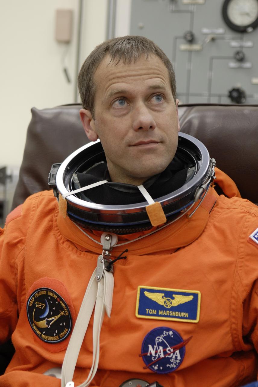 CAPE CANAVERAL, Fla. –  In the Operations and Checkout Building at NASA's Kennedy Space Center in Florida, STS-127 Mission Specialist Tom Marshburn puts on his launch-and-entry suit. He and other crew members will be heading for Launch Pad 39A for a simulated launch countdown. The crew is at Kennedy for a launch dress rehearsal called the terminal countdown demonstration test, or TCDT, which includes emergency exit training and equipment familiarization.  Endeavour's STS-127 mission is the final of three flights dedicated to the assembly of the Japanese Kibo laboratory complex on the International Space Station.  Endeavour's launch is scheduled for June 13 at 7:17 a.m. EDT.  Photo credit: NASA/Kim Shiflett