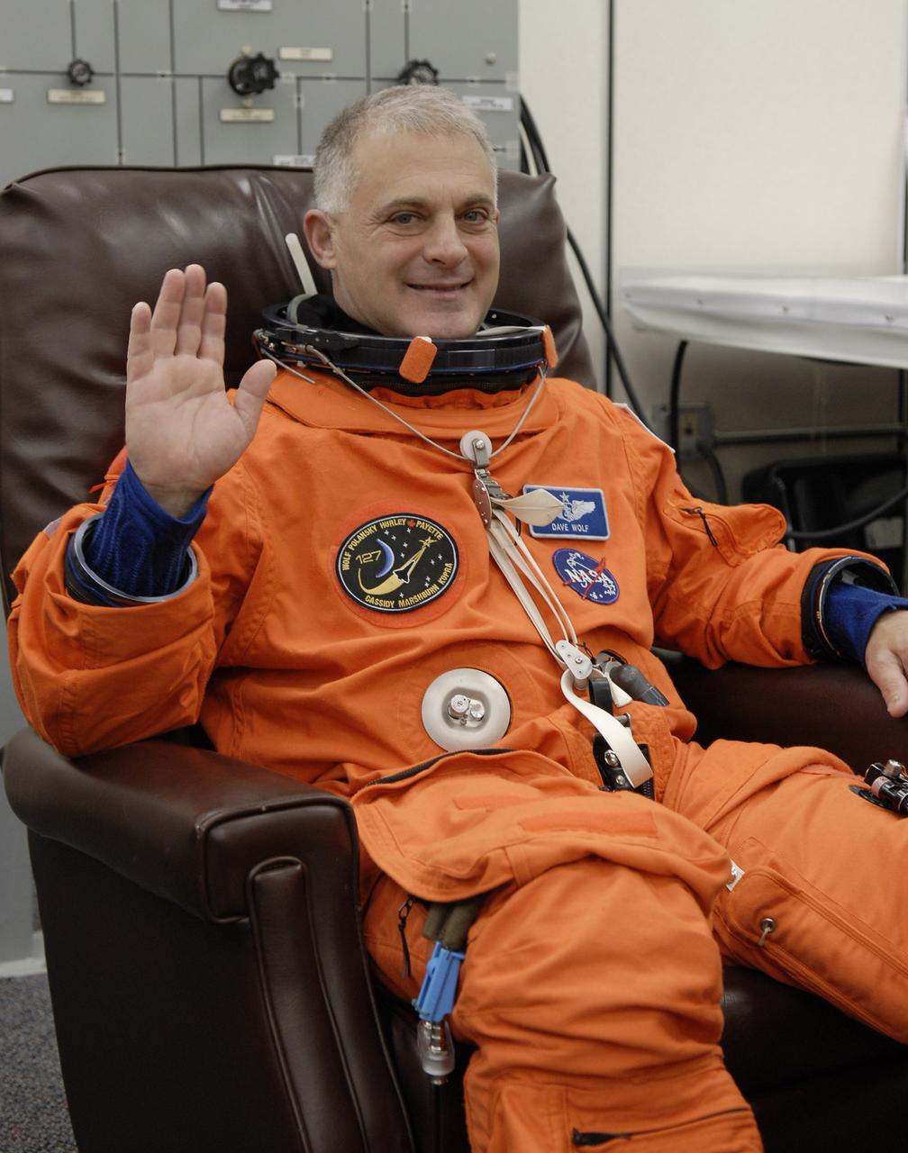 CAPE CANAVERAL, Fla. –  In the Operations and Checkout Building at NASA's Kennedy Space Center in Florida, STS-127 Mission Specialist Dave Wolf puts on his launch-and-entry suit. He and other crew members will be heading for Launch Pad 39A for a simulated launch countdown. The crew is at Kennedy for a launch dress rehearsal called the terminal countdown demonstration test, or TCDT, which includes emergency exit training and equipment familiarization.  Endeavour's STS-127 mission is the final of three flights dedicated to the assembly of the Japanese Kibo laboratory complex on the International Space Station.  Endeavour's launch is scheduled for June 13 at 7:17 a.m. EDT.  Photo credit: NASA/Kim Shiflett
