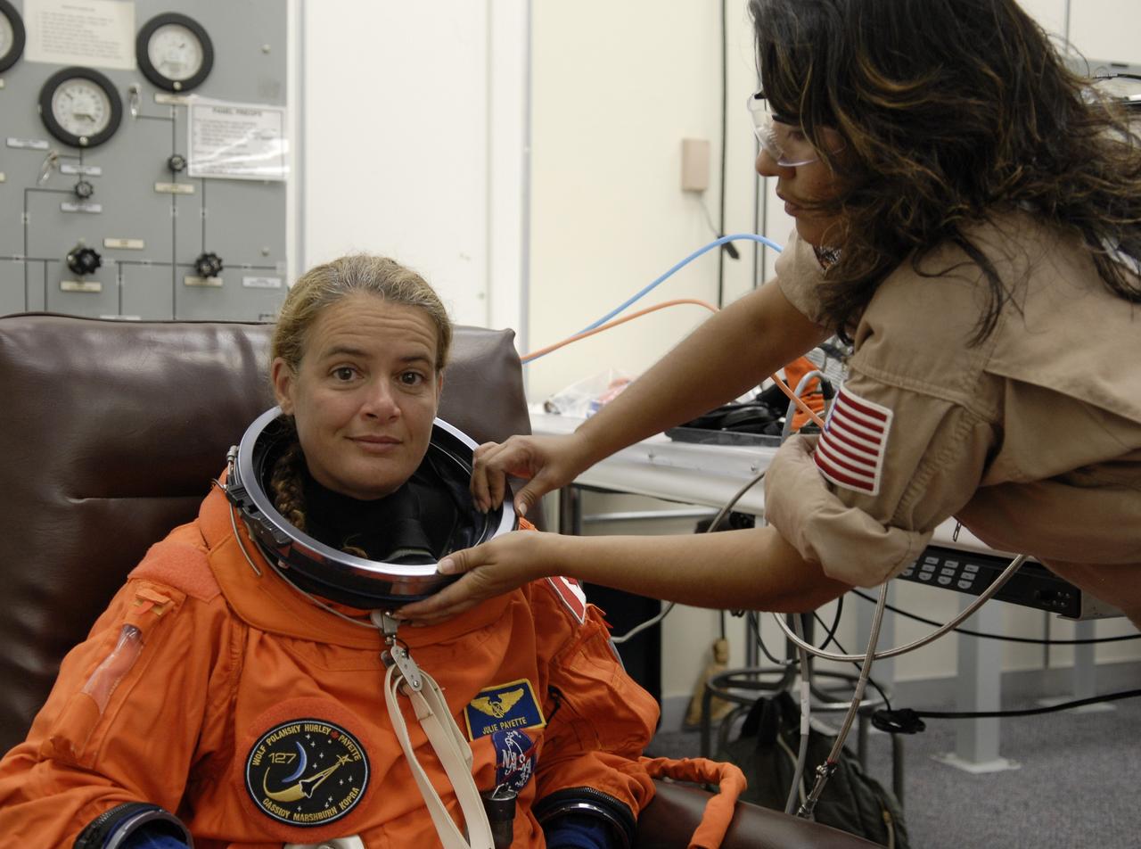 CAPE CANAVERAL, Fla. –  In the Operations and Checkout Building at NASA's Kennedy Space Center in Florida, STS-127 Mission Specialist Julie Payette is helped with her launch-and-entry suit.  She and other crew members will be heading for Launch Pad 39A for a simulated launch countdown.  The crew is at Kennedy for a launch dress rehearsal called the terminal countdown demonstration test, or TCDT, which includes emergency exit training and equipment familiarization.  Endeavour's STS-127 mission is the final of three flights dedicated to the assembly of the Japanese Kibo laboratory complex on the International Space Station.  Endeavour's launch is scheduled for June 13 at 7:17 a.m. EDT.  Photo credit: NASA/Kim Shiflett