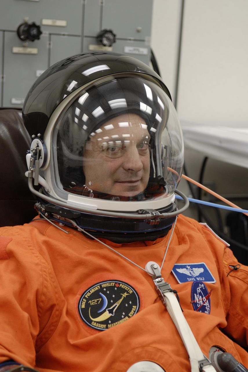 CAPE CANAVERAL, Fla. –  In the Operations and Checkout Building at NASA's Kennedy Space Center in Florida, STS-127 Mission Specialist Dave Wolf checks the communication system in his helmet. He and other crew members will be heading for Launch Pad 39A for a simulated launch countdown. The crew is at Kennedy for a launch dress rehearsal called the terminal countdown demonstration test, or TCDT, which includes emergency exit training and equipment familiarization.  Endeavour's STS-127 mission is the final of three flights dedicated to the assembly of the Japanese Kibo laboratory complex on the International Space Station.  Endeavour's launch is scheduled for June 13 at 7:17 a.m. EDT.  Photo credit: NASA/Kim Shiflett