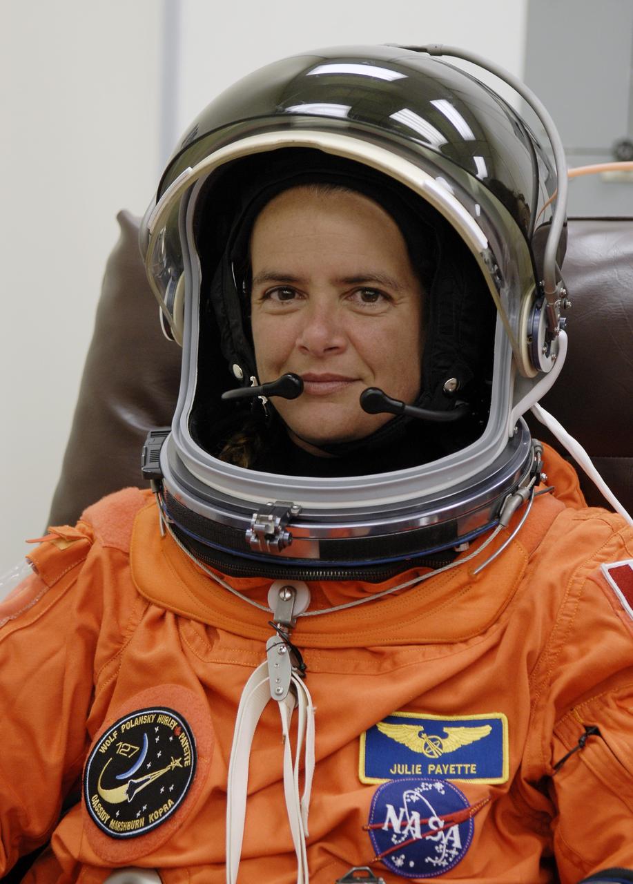 CAPE CANAVERAL, Fla. –  In the Operations and Checkout Building at NASA's Kennedy Space Center in Florida, STS-127 Mission Specialist Julie Payette checks the communication system in her helmet. She and other crew members will be heading for Launch Pad 39A for a simulated launch countdown. The crew is at Kennedy for a launch dress rehearsal called the terminal countdown demonstration test, or TCDT, which includes emergency exit training and equipment familiarization.  Endeavour's STS-127 mission is the final of three flights dedicated to the assembly of the Japanese Kibo laboratory complex on the International Space Station.  Endeavour's launch is scheduled for June 13 at 7:17 a.m. EDT.  Photo credit: NASA/Kim Shiflett