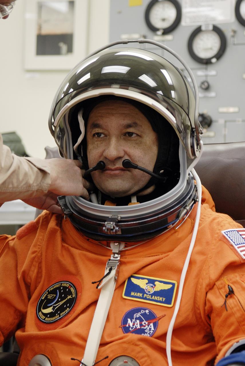 CAPE CANAVERAL, Fla. –  In the Operations and Checkout Building at NASA's Kennedy Space Center in Florida, STS-127 Commander Mark Polansky checks the communication system in his helmet. He and other crew members will be heading for Launch Pad 39A for a simulated launch countdown. The crew is at Kennedy for a launch dress rehearsal called the terminal countdown demonstration test, or TCDT, which includes emergency exit training and equipment familiarization.  Endeavour's STS-127 mission is the final of three flights dedicated to the assembly of the Japanese Kibo laboratory complex on the International Space Station.  Endeavour's launch is scheduled for June 13 at 7:17 a.m. EDT.  Photo credit: NASA/Kim Shiflett