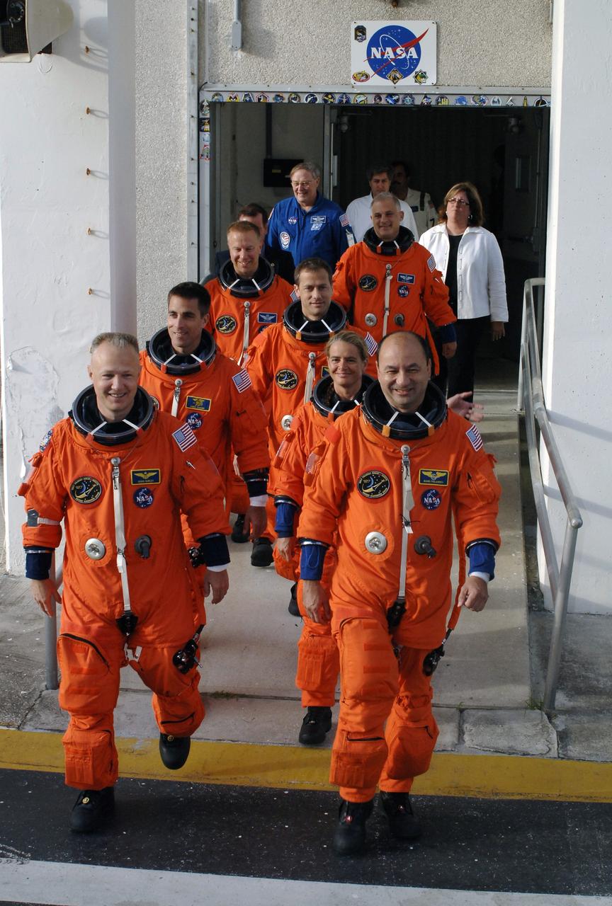 CAPE CANAVERAL, Fla. – STS-127 crew members exit the Operations and Checkout Building on their way to Launch Pad 39A at NASA's Kennedy Space Center in Florida for a simulated launch countdown. Leading the way, at right, is Commander Mark Polansky. From left, clockwise, are Pilot Doug Hurley and Mission Specialists Christopher Cassidy, Tim Kopra, Dave Wolf, Tom Marshburn and Julie Payette, who represents the Canadian Space Agency. The crew is at Kennedy for a launch dress rehearsal called the terminal countdown demonstration test, or TCDT, which includes emergency exit training and equipment familiarization. Endeavour's STS-127 mission is the final of three flights dedicated to the assembly of the Japanese Kibo laboratory complex on the International Space Station. Endeavour's launch is scheduled for June 13 at 7:17 a.m. EDT. Photo credit: NASA/Kim Shiflett