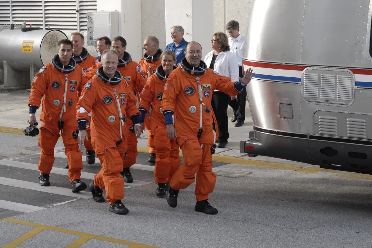 CAPE CANAVERAL, Fla. – STS-127 crew members walk toward the Astrovan that will taken them to Launch Pad 39A at NASA's Kennedy Space Center in Florida for a simulated launch countdown. In the foreground are Pilot Doug Hurley (left) and Commander Mark Polansky. Behind them are Mission Specialists Christopher Cassidy, Tim Kopra, Tom Marshburn, Dave Wolf and Julie Payette, who represents the Canadian Space Agency. The crew is at Kennedy for a launch dress rehearsal called the terminal countdown demonstration test, or TCDT, which includes emergency exit training and equipment familiarization. Endeavour's STS-127 mission is the final of three flights dedicated to the assembly of the Japanese Kibo laboratory complex on the International Space Station. Endeavour's launch is scheduled for June 13 at 7:17 a.m. EDT. Photo credit: NASA/Kim Shiflett