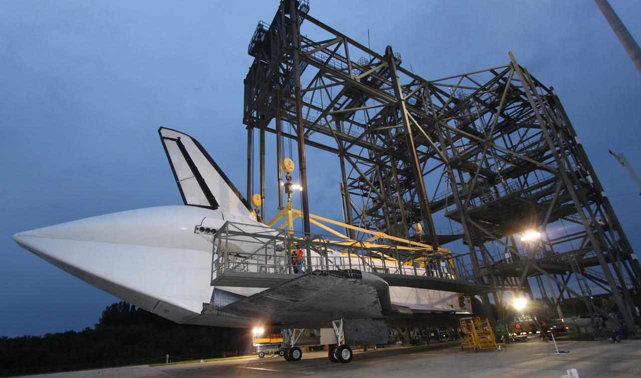 CAPE CANAVERAL, Fla. – On the Shuttle Landing Facility at NASA's Kennedy Space Center in Florida, the hoist is ready to be removed from space shuttle Atlantis before it is towed to Orbiter Processing Facility 1. Covering the rear of Atlantis is a tail cone, which protects the aft engine area and provides a more efficient aeronautical dimension during its piggyback flight. After its May 24 landing at Edwards Air Force Base in California, which concluded its STS-125 mission, the modified Boeing 747 SCA carried the shuttle on a two-day ferry flight from Edwards to Kennedy beginning June 1. Atlantis' next assignment is the STS-129 mission, targeted to launch in November 2009. Photo credit: NASA/Jack Pfaller