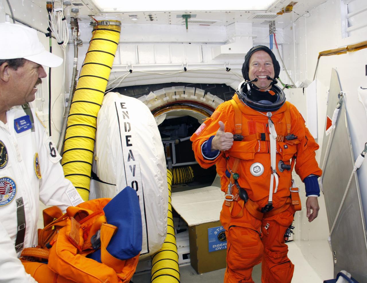 CAPE CANAVERAL, Fla. –  In the White Room on the orbiter access arm of the fixed service structure on Launch Pad 39A at NASA's Kennedy Space Center in Florida, STS-127 Mission Specialist Tim Kopra is ready to enter space shuttle Endeavour for the simulated launch countdown.  The crew is at Kennedy for a launch dress rehearsal called the terminal countdown demonstration test, or TCDT, which includes the simulation, emergency exit training and equipment familiarization.  Endeavour's STS-127 mission is the final of three flights dedicated to the assembly of the Japanese Kibo laboratory complex on the International Space Station.  Endeavour's launch is scheduled for June 13 at 7:17 a.m. EDT.  Photo credit: NASA/Troy Cryder